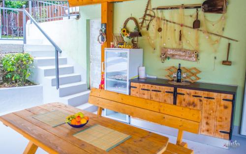 a kitchen with a table and a refrigerator at Retro Pool House in Mostar