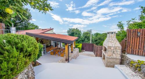 a garden with a pavilion and a vase at Retro Pool House in Mostar