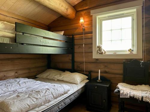 a bedroom with a bunk bed in a log cabin at Large log cabin at Sjusjøen with sauna, fireplace and panoramic view in Ringsaker