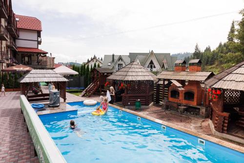 a group of people in a pool at a resort at Milli&Jon SPA in Bukovel