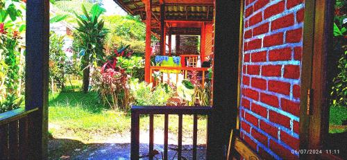 an open door to a garden outside a house at Ariel Bungalow Tetebatu in Tetebatu