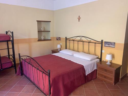 a bedroom with a large bed with a red blanket at Country House Agriturismo Ciuccunit in Bucchianico