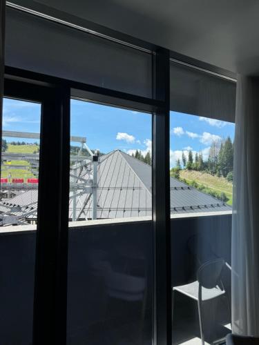 a view from the window of a house at SAVOIE Apartments Bukovel in Bukovel