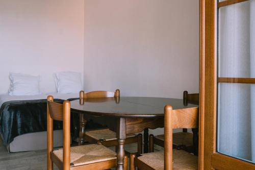 a room with a table and chairs and a bed at Creste E Mare in Ajaccio