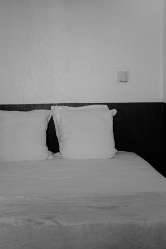 a bed with two pillows on top of it at Creste E Mare in Ajaccio