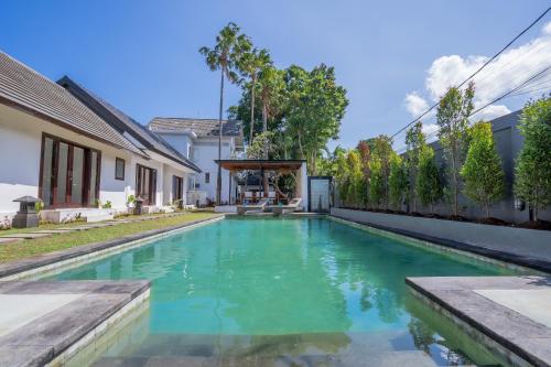 a swimming pool in the backyard of a house at Olivia Estate by Villas Direct Bali in Seminyak