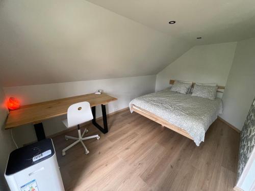 a small bedroom with a bed and a desk at Ratasvälja Apartment Seppen in Lohkva