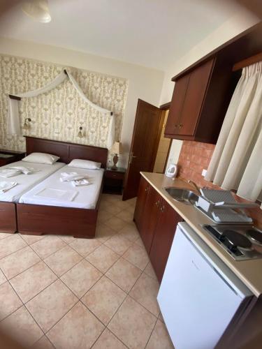 a small room with a bed and a sink at Hotel Hera in Skala Potamias