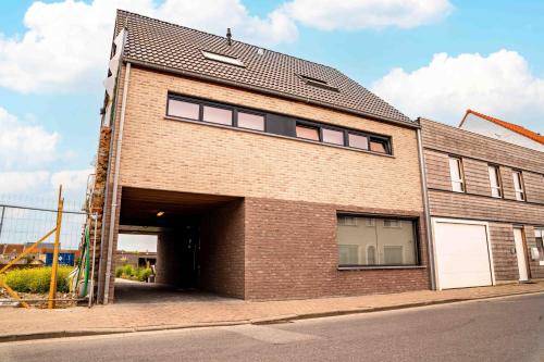 a large brick building with a garage at Oase 't Huyseke in Blankenberge