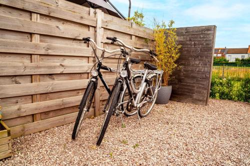 a bike parked next to a wooden fence at Oase 't Huyseke in Blankenberge