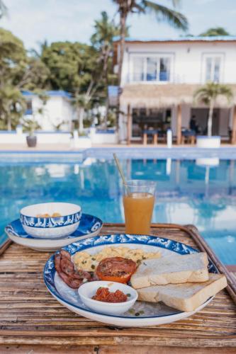 a plate of food on a table next to a pool at Amor Resort Koh Rong in Koh Rong Island