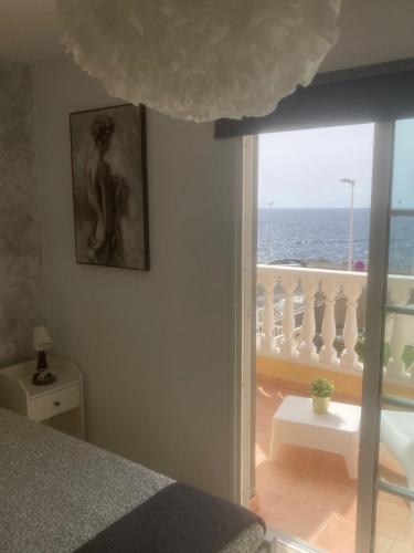 a bedroom with a bed and a view of the ocean at Chalet Ocean in El Médano