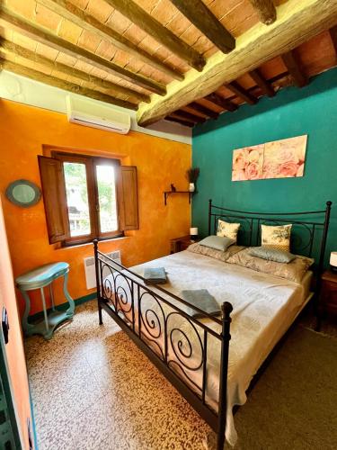 a bedroom with a large bed with green walls at Turquoise Rose Apartment in Peccioli