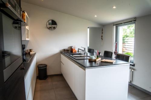 a kitchen with a black counter top in a room at Oase 't Huyseke in Blankenberge