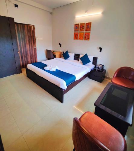 a bedroom with a large bed and a television at 488, The Nook in Bhubaneshwar