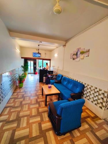 a lobby with a blue couch and a table at 488, The Nook in Bhubaneshwar