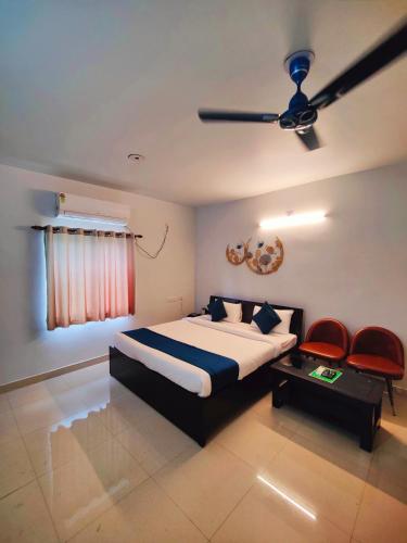 a bedroom with a bed and a ceiling fan at 488, The Nook in Bhubaneshwar