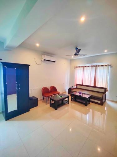 a living room with two tables and two chairs at 488, The Nook in Bhubaneshwar