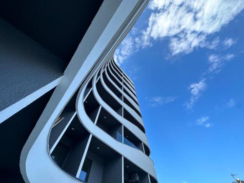 a building with a spiral tower with the sky in the background at Aral Apartments - Shengjin City Gate in Shëngjin