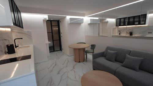 a living room with a couch and a table at Club Inn Appartement in Nice