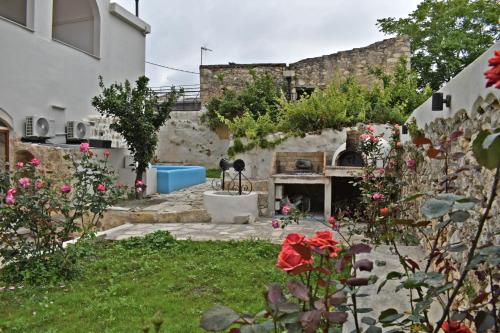 a garden with a stone fireplace in a yard at NiAmalFi Apartments in Atsipopoulo