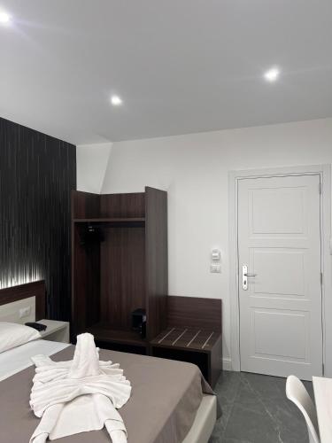 a bedroom with a bed with towels on it at Hotel Blanc in Casoria