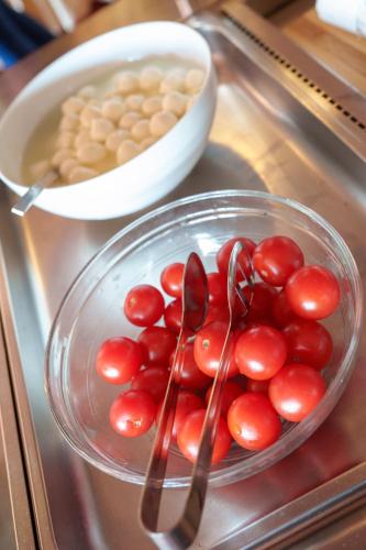 a bowl of tomatoes and beans and spoons on a counter at Hotel Villa Strassoldo "Ex Attianese Hotel Restaurant" in Cervignano del Friuli