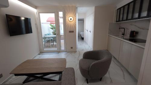a living room with a chair and a table at Club Inn Appartement in Nice