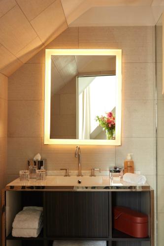 a bathroom with a sink and a mirror at Hotel La Villa Saint Germain Des Prés in Paris