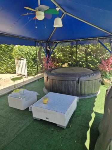 a patio with an umbrella and a table and chairs at VILLA Soleil et Douceur in La Seyne-sur-Mer
