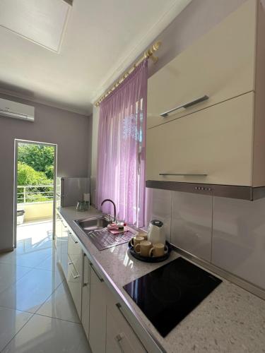a kitchen with a sink and a counter top at MEGA Apartments in Fushë-Draç