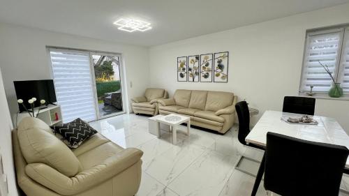 a living room with two couches and a table at Neue Wohnung für 4 Küche Terrasse in Wittlich