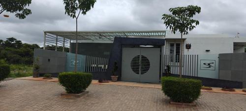 a building with a door and some bushes at S R Private Residence in Mysore
