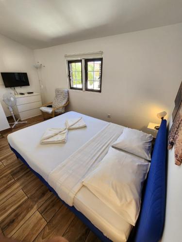 a bedroom with a large bed with two towels on it at Blife Faro Beach Hostel & Rooms in Faro