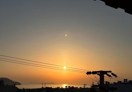 a sunset over the ocean with the sun in the sky at Wonderful Sunset in Turgutreis