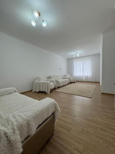 a white room with four beds in a row at ЦО Diamond resort Иссык-Куль Киргизия in Bosteri
