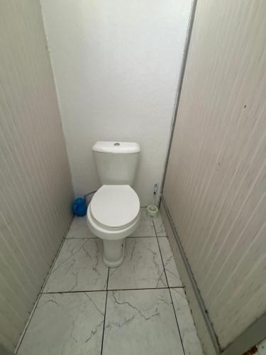 a small bathroom with a toilet in a stall at Hostel,halal in Tokmok