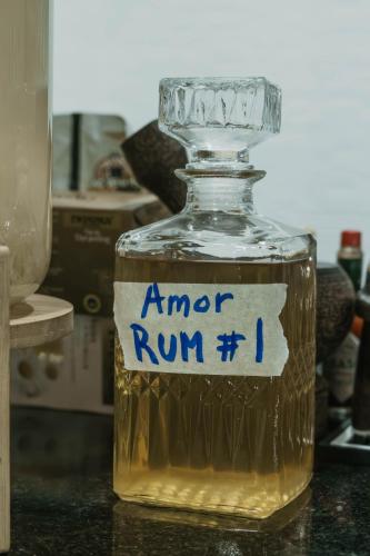 a bottle of alcohol sitting on a table with a sticker on it at Amor Resort Koh Rong in Koh Rong Island