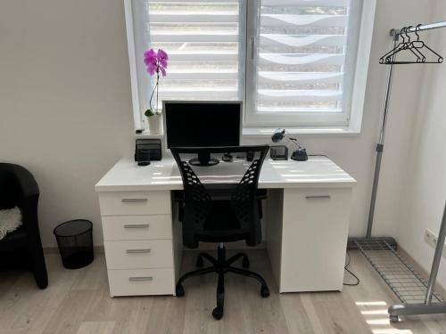 an office with a desk with a computer on it at Neue Wohnung für 4 Küche Terrasse in Wittlich