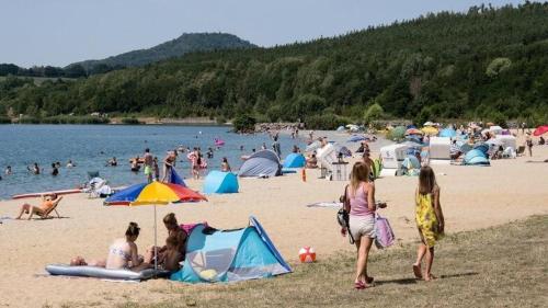 a group of people on a beach with tents at Berzi Ferienwohnung 1 Görlitz in Görlitz