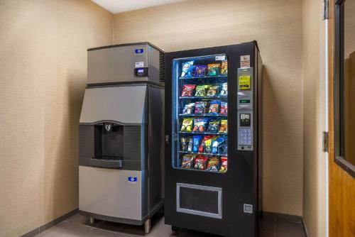 a vending machine with drinks and snacks in a room at Comfort Inn & Suites At CrossPlex Village in Birmingham