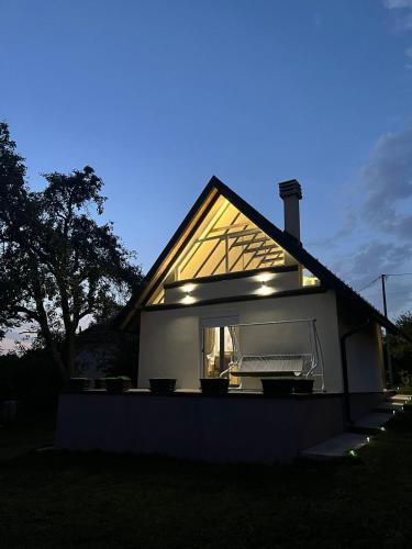 a house with lights on the side of it at Vikendica Živković in Lazarevac