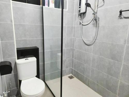 a bathroom with a shower with a toilet in it at IPOH MENGLEMBU LOHAS 4BR3Bath14 PAX in Ipoh