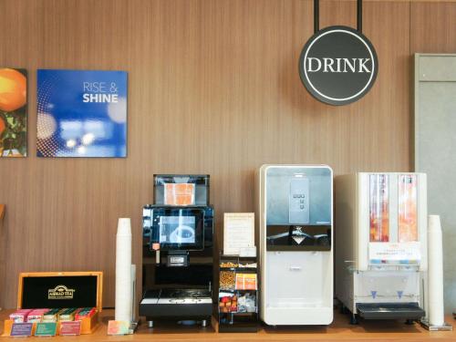 a office with a display with a drink sign on the wall at Comfort Hotel Nagoya Kanayama in Nagoya