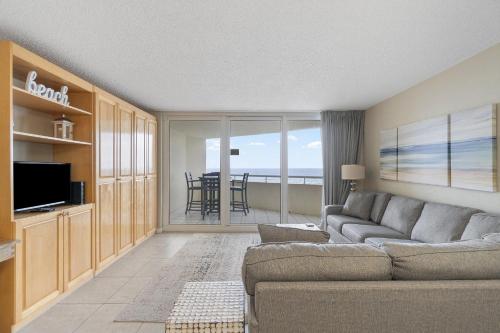 a living room with a couch and a television at Perdido Sun 304 in Perdido Key