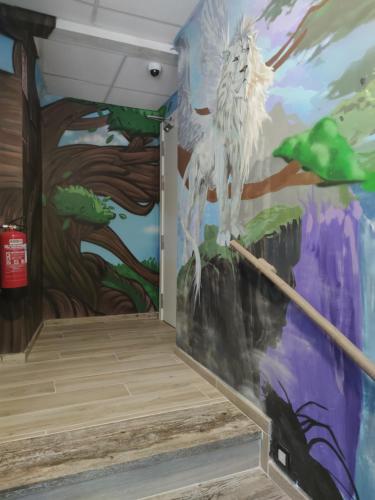 a mural in a room with a painting on the wall at FamilyHostelPinto in Pinto
