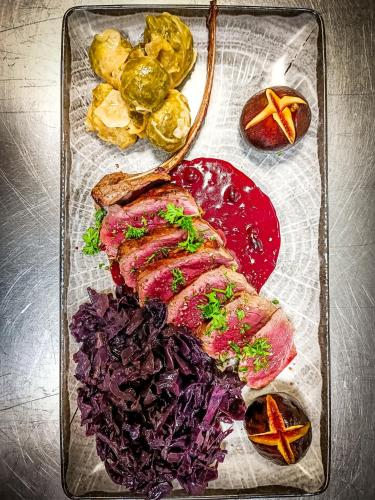 a tray of food with meat and vegetables on it at Auberge du château de Joux in La Cluse et Mijoux