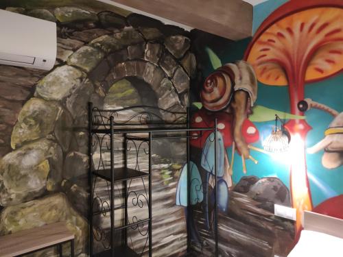 a room with a painting of a door in a stone wall at FamilyHostelPinto in Pinto