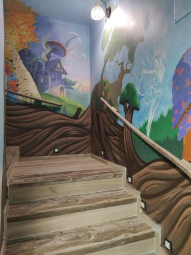 a mural on the wall of a room with stairs at FamilyHostelPinto in Pinto
