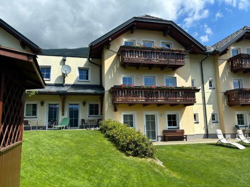 a large building with balconies and a yard at Eckenhof in Sankt Michael im Lungau